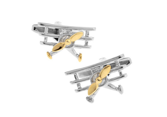 A pair of gold-colored cufflinks shaped like a triplane airplane, with a rhodium-plated base metal.