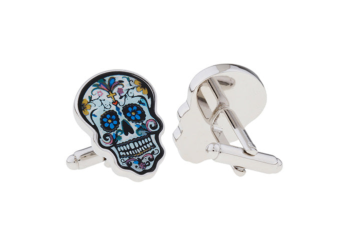 Colorful skull-shaped cufflinks on a white background