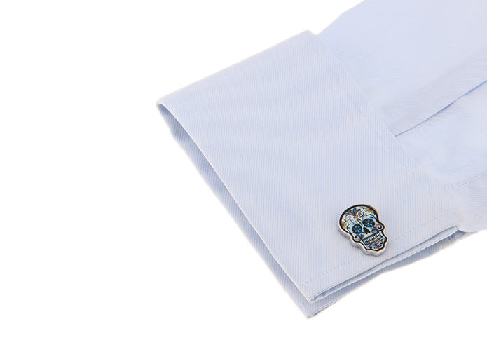 Cufflink with skull design on a white shirt cuff