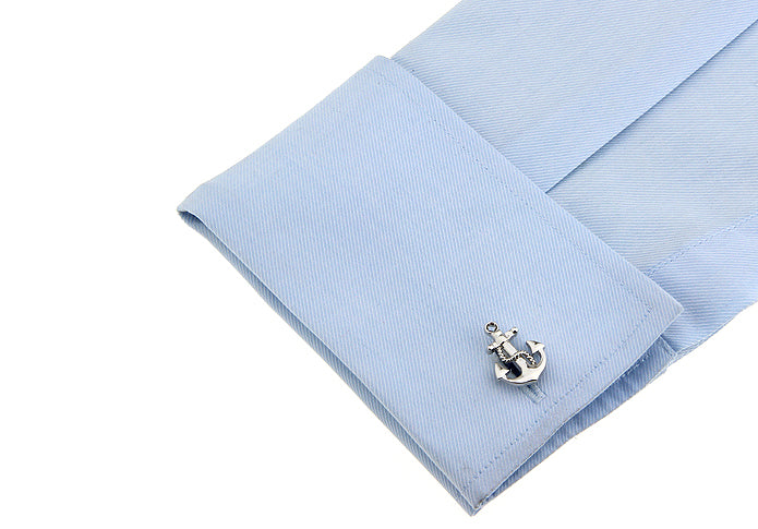 Light blue dress shirt with anchor cufflink on a white background