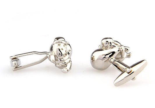 Silver lion-shaped cufflinks on a white background