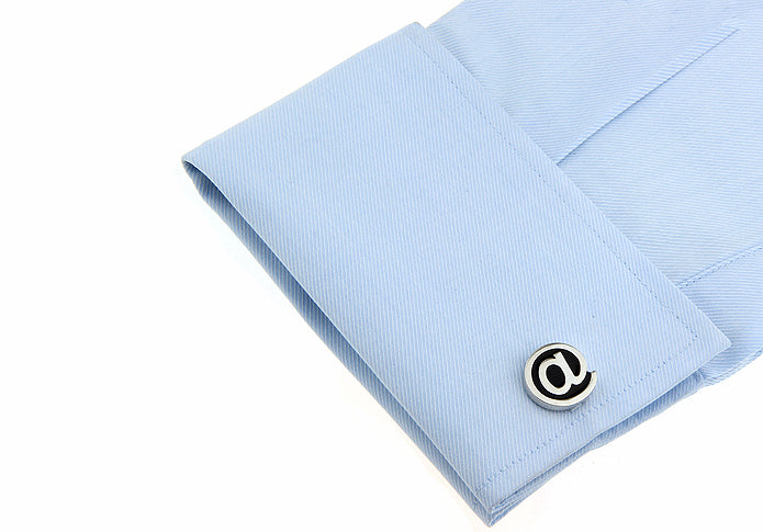 Light blue dress shirt with a cufflink on a white background