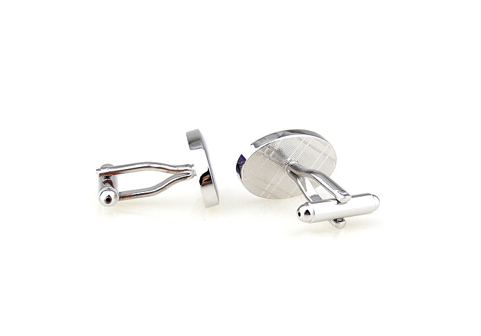 Silver cufflinks on a white background