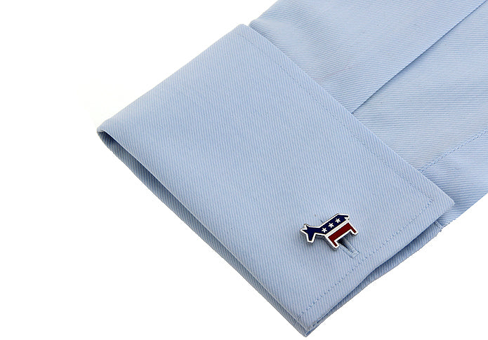 Cufflink on a light blue shirt cuff with a white background