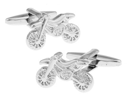 A pair of silver cufflinks featuring a detailed 3D design of a motocross motorcycle.