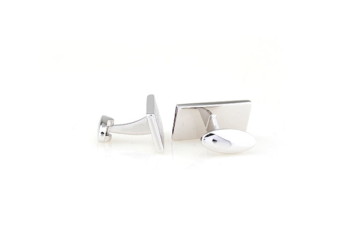 Silver cufflinks on a white background