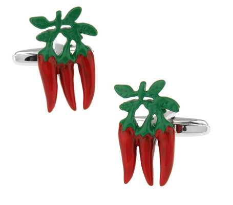Red chili pepper cufflinks with green leaves on a white background