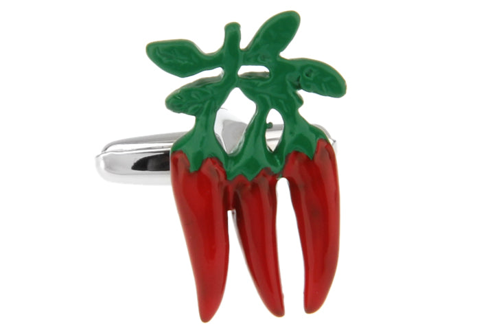Cufflink with red chili peppers and green leaves on a white background