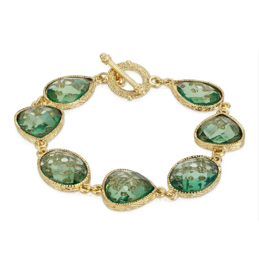 A gold-colored bracelet with light aqua blue faceted toggle design around the beads.