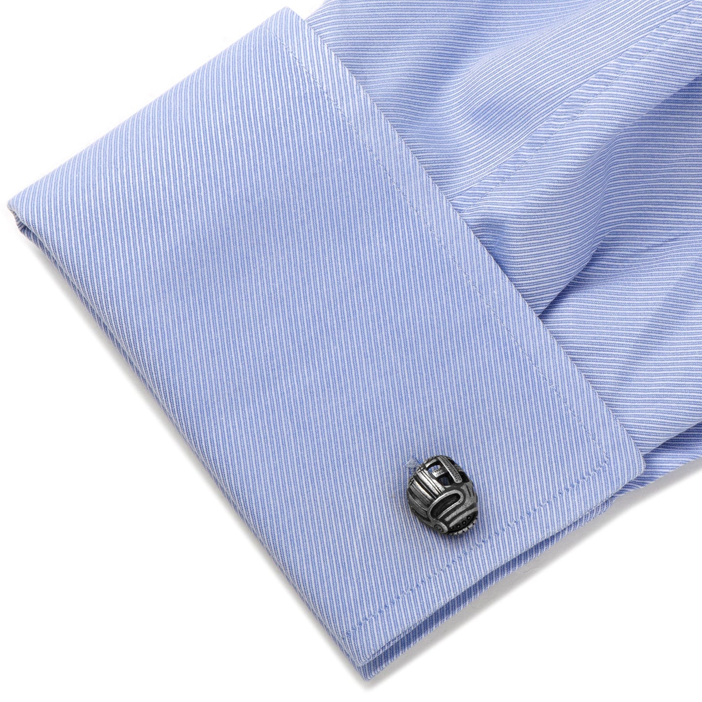 Cufflink on a light blue striped shirt cuff