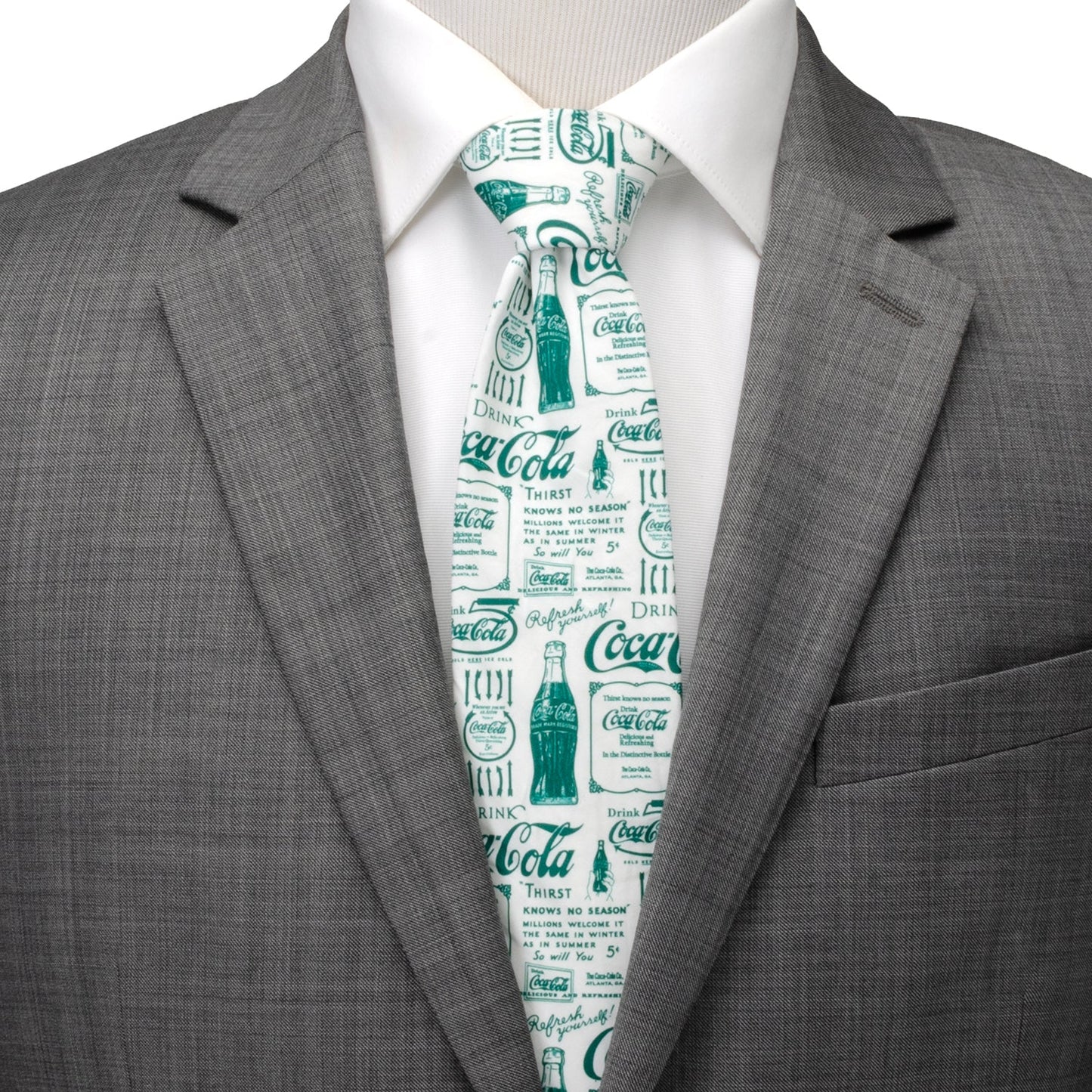 Gray suit jacket with a white shirt and Coca-Cola tie on a mannequin.
