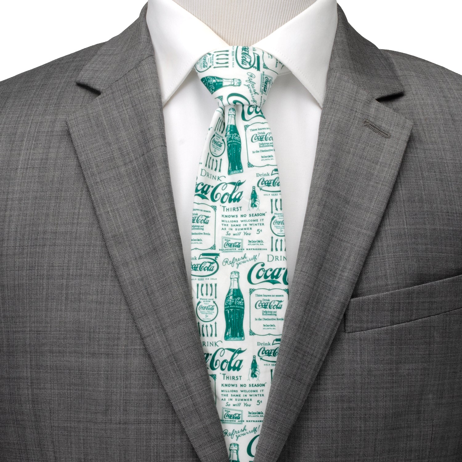 Gray suit jacket with a white shirt and Coca-Cola tie on a mannequin.