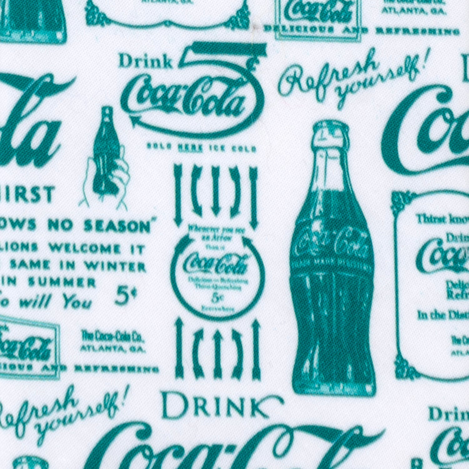 Coca-Cola fabric with vintage-style text and bottle graphics on a white background