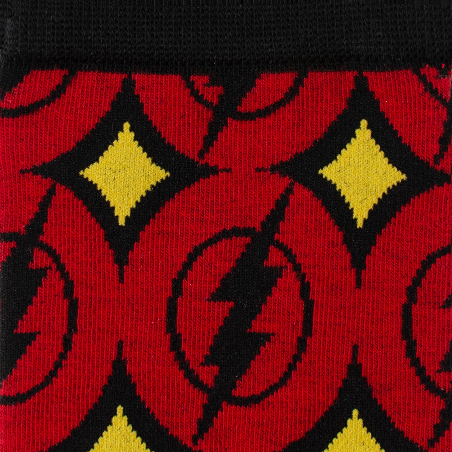 Close-up of socks with red, black, and yellow pattern