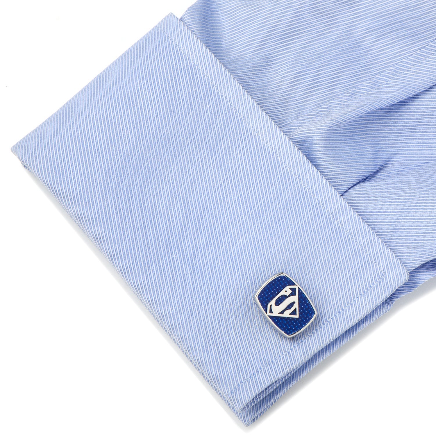 Blue cufflink on a light blue striped shirt