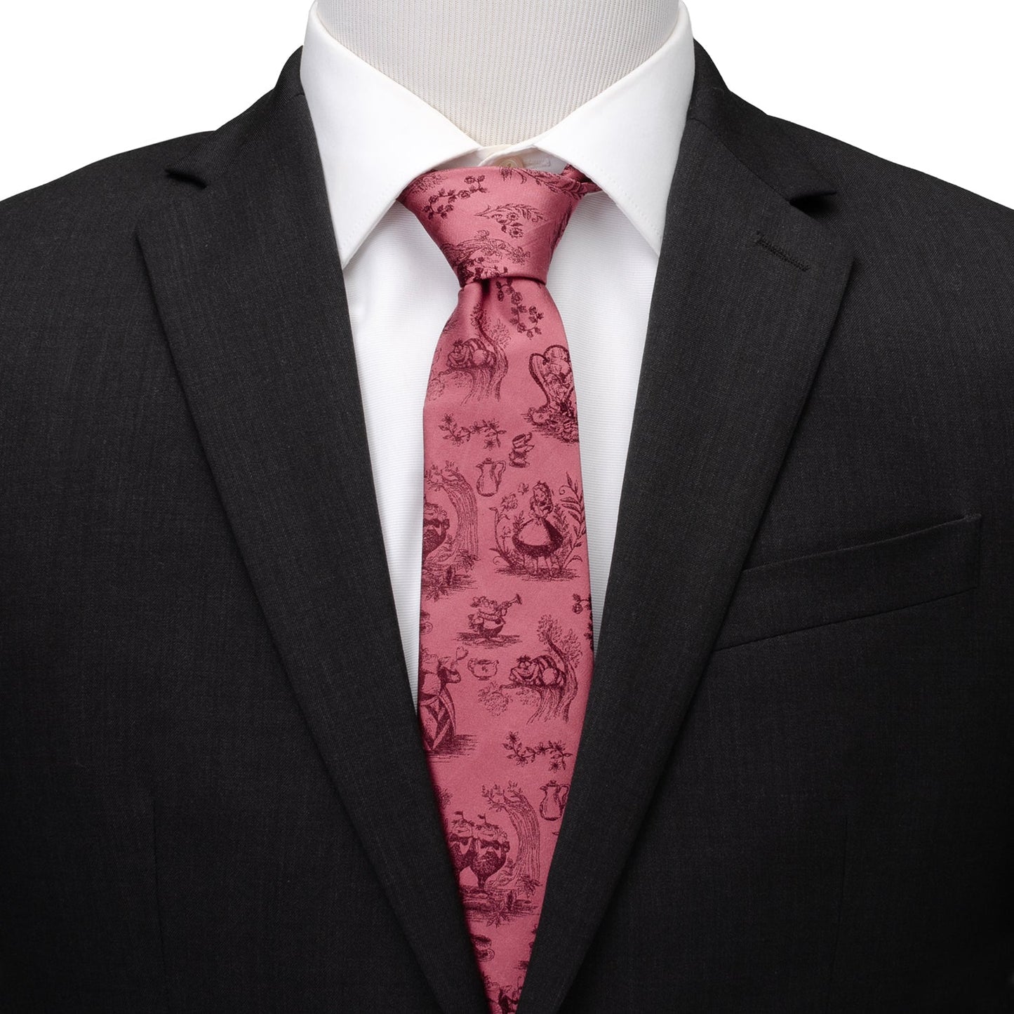 Black suit with a white shirt and pink patterned tie on a mannequin. Alice in Wonderland