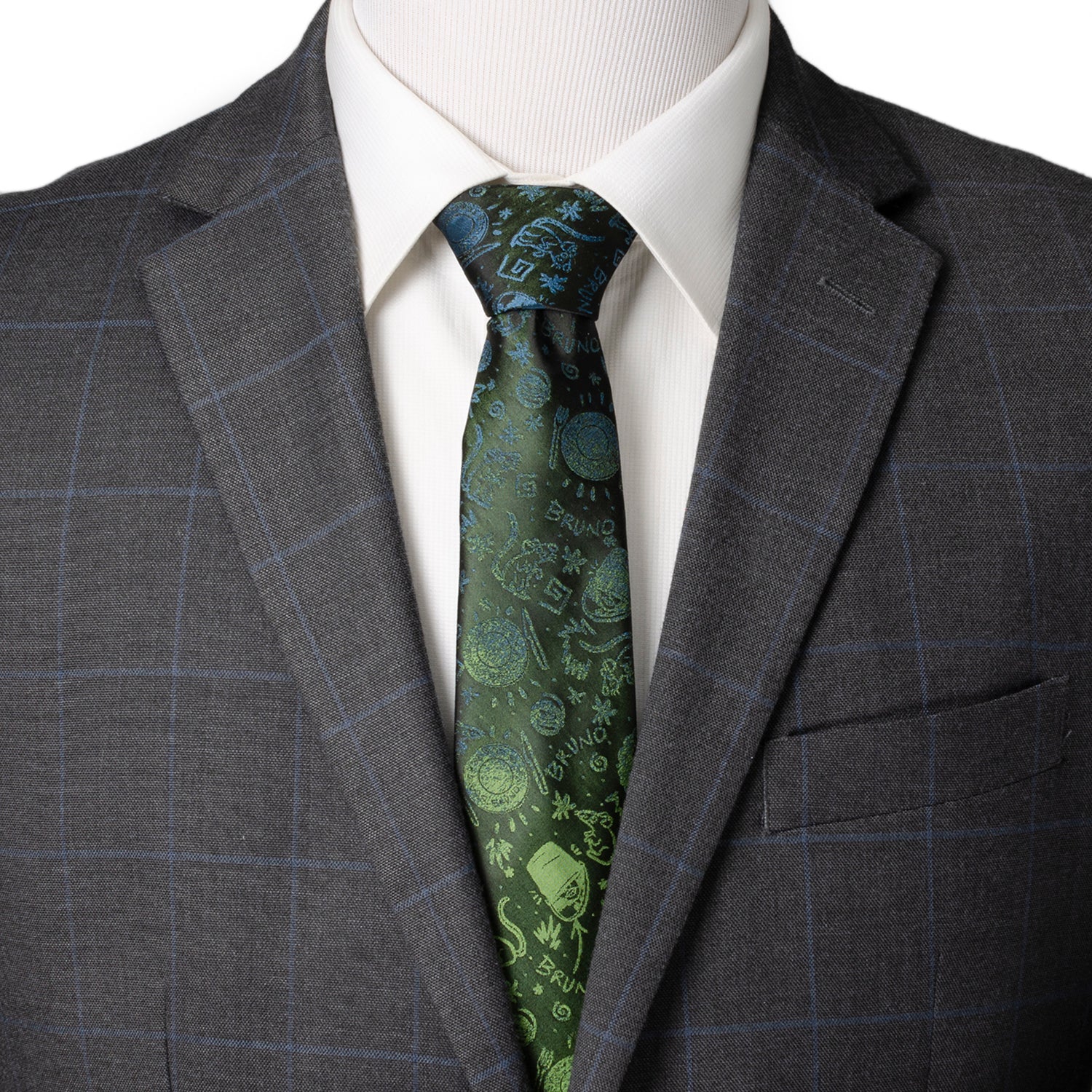Gray suit jacket with a white shirt and green patterned tie on a mannequin. Encanto Bruno