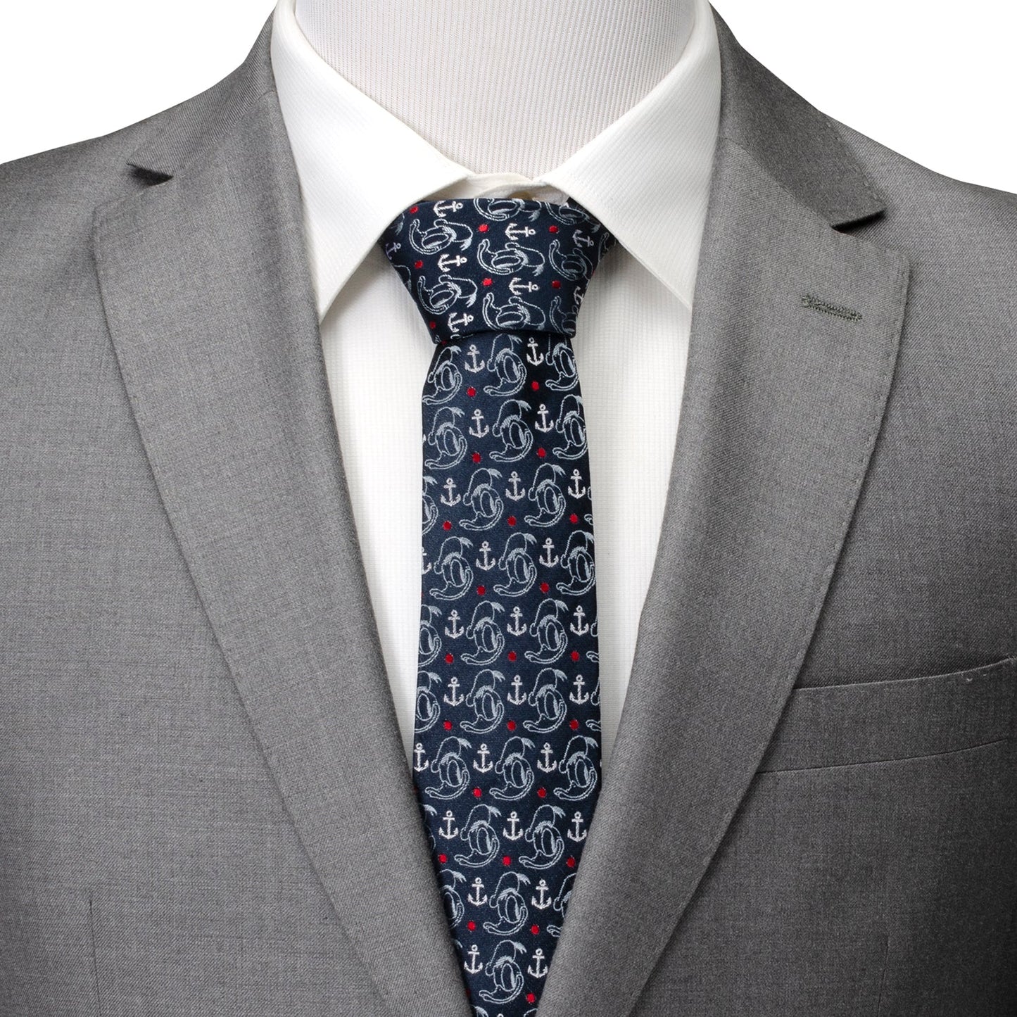 Gray suit with a white shirt and patterned tie on a plain background