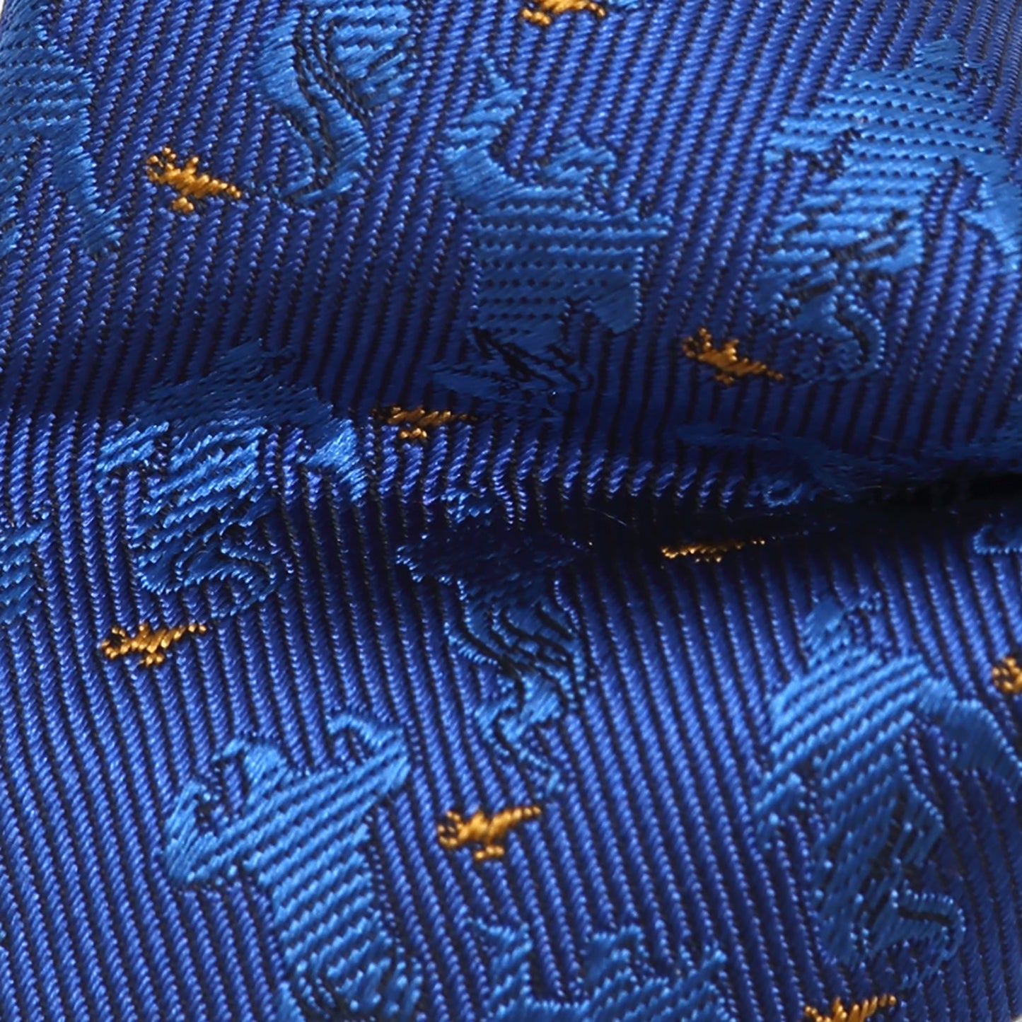 Close-up of a blue tie with gold patterns Aladdin Genie