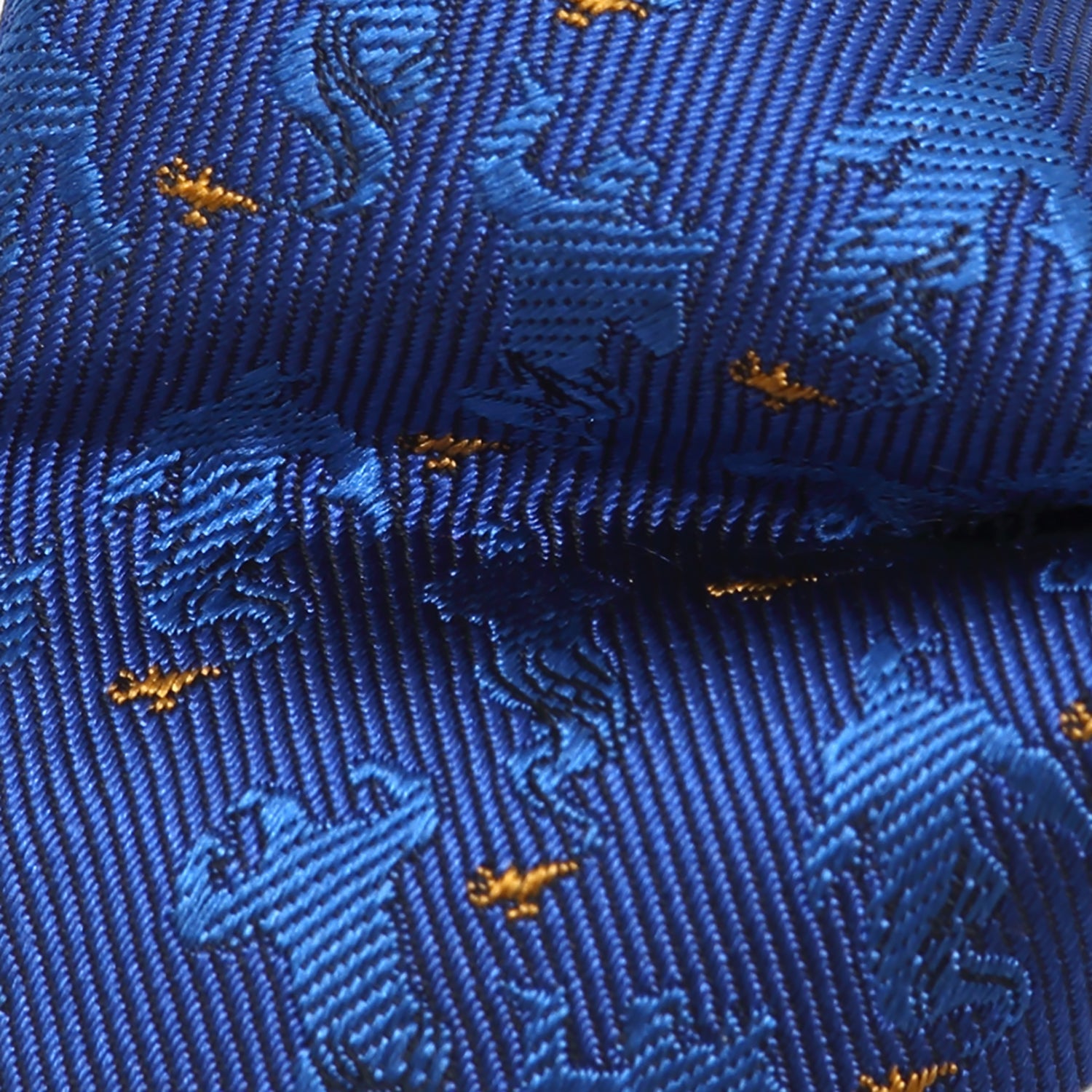 Close-up of a blue tie with gold patterns Aladdin Genie