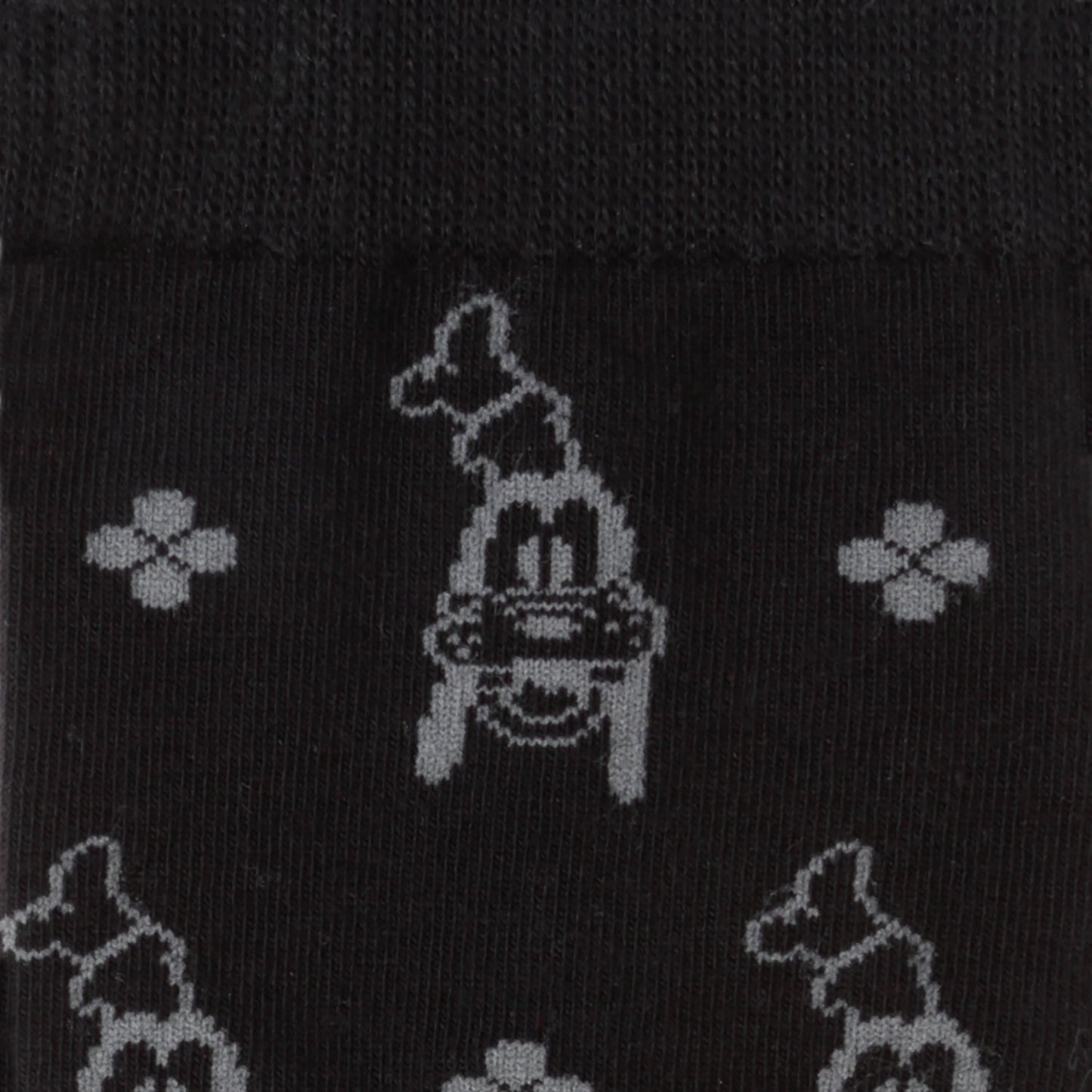 Black socks with white graphic design of a car and flowers on a black background