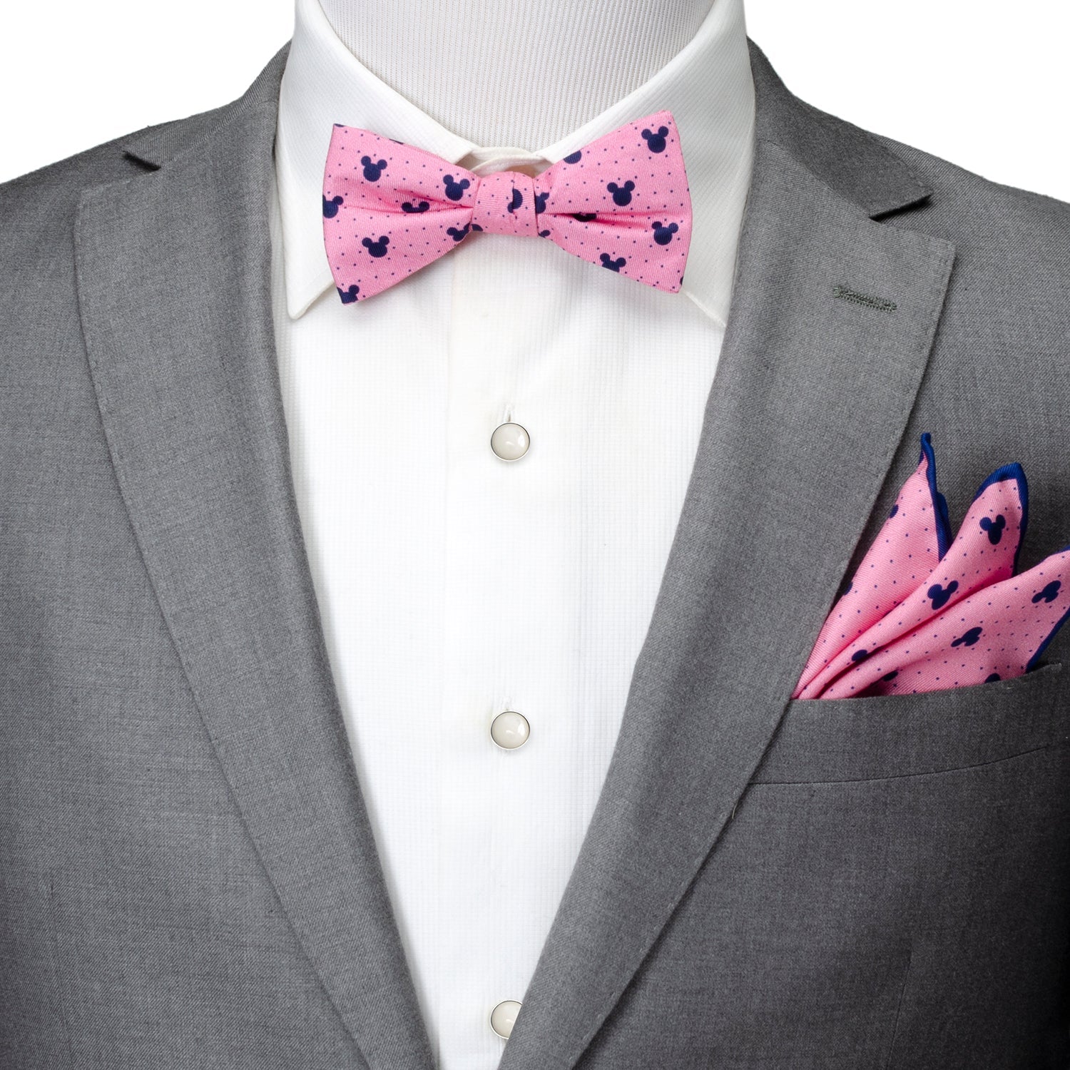 Gray suit with pink bow tie and pocket square on a white background