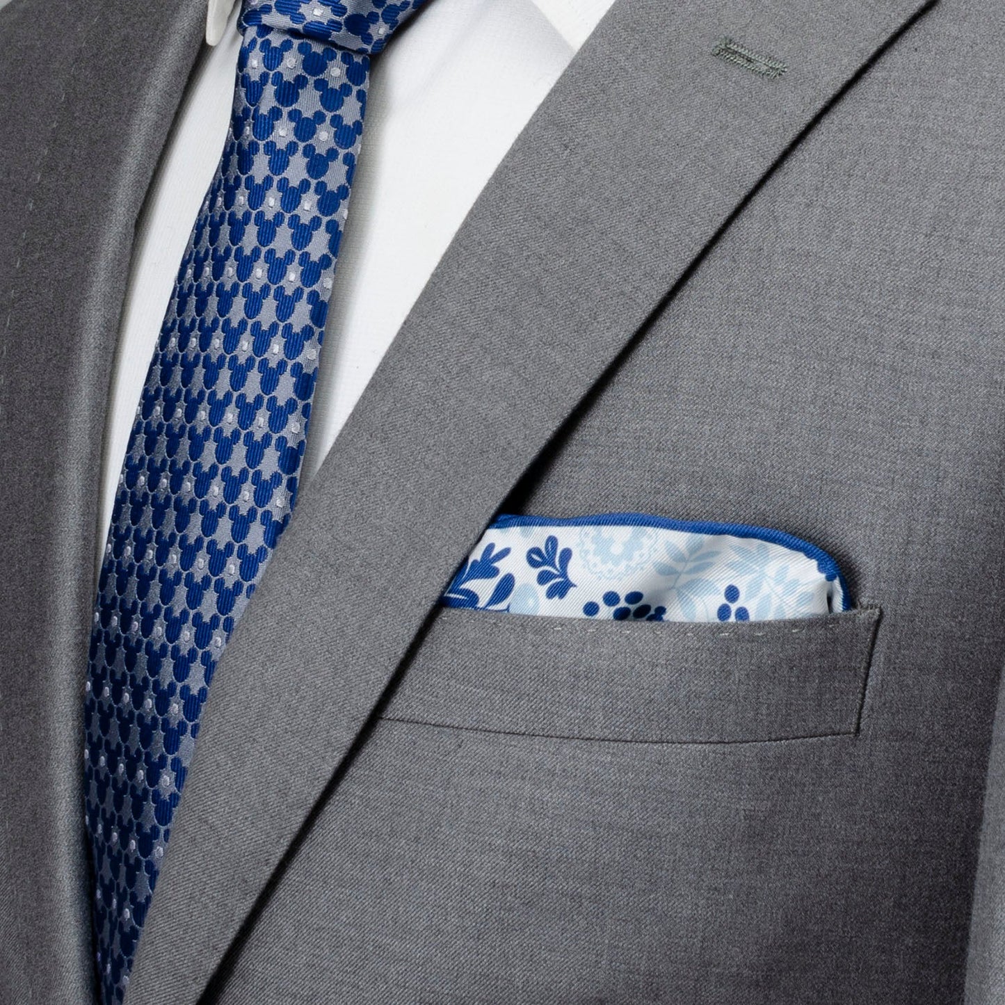Gray suit with blue patterned tie and pocket square