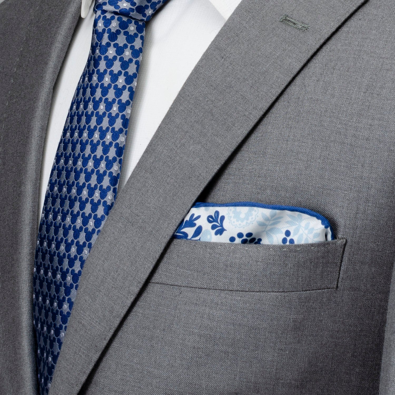 Gray suit with blue patterned tie and pocket square