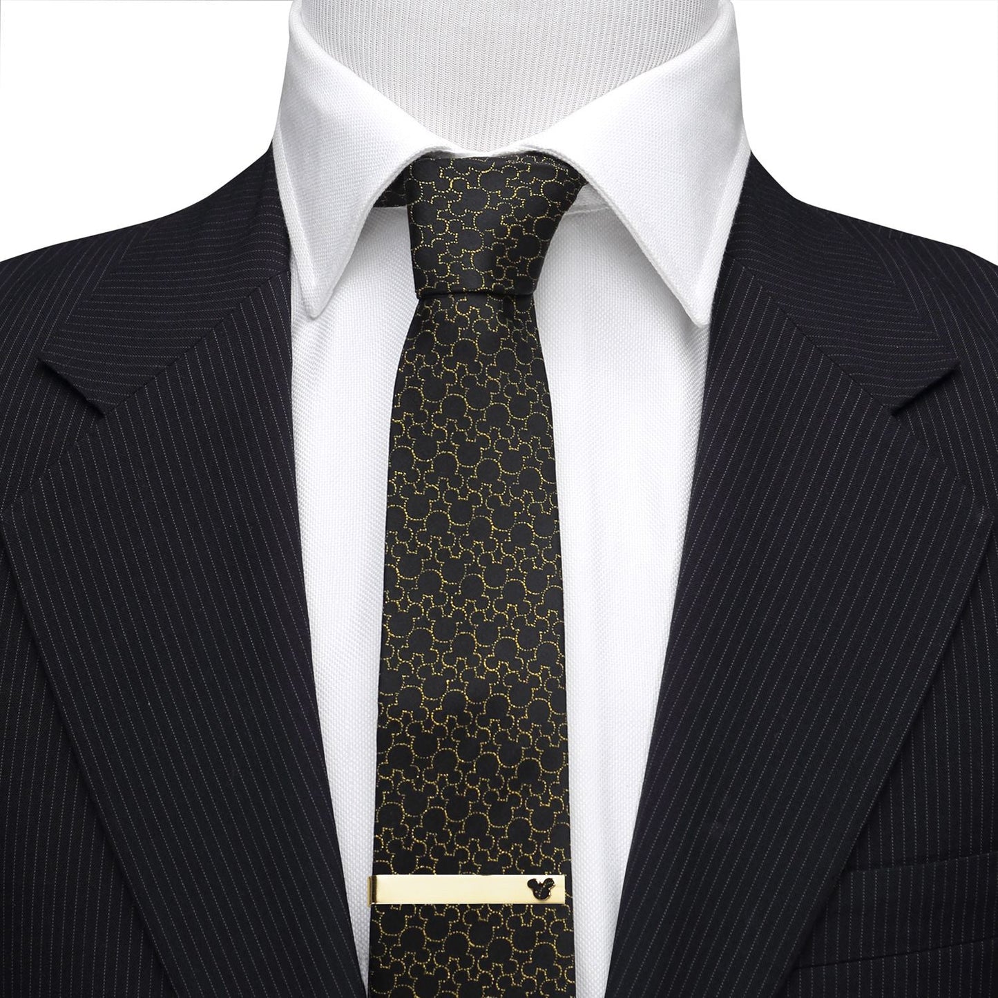 Black patterned tie with gold accents on a suit and white shirt