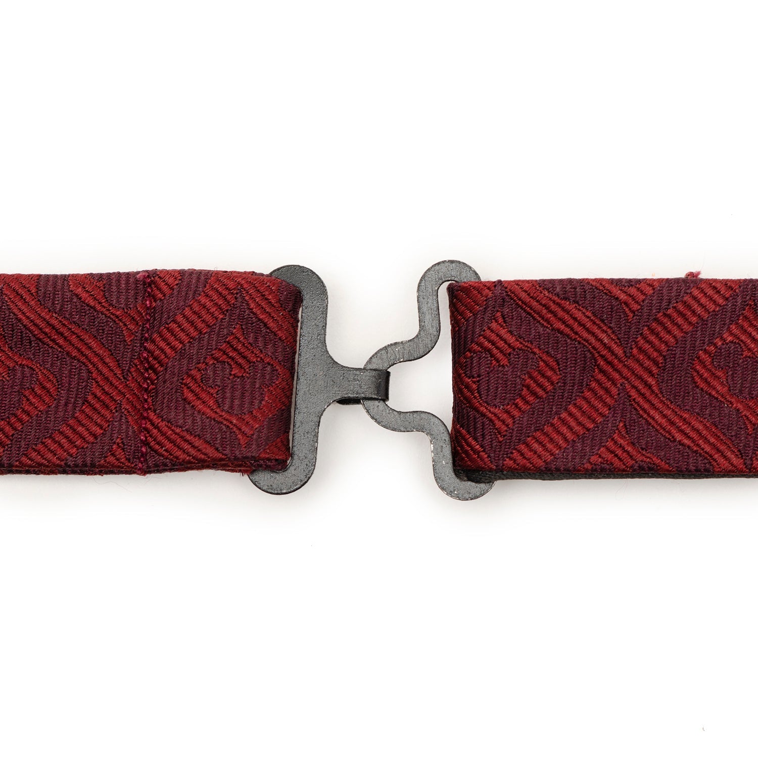 Red woven belt with a silver buckle on a white background