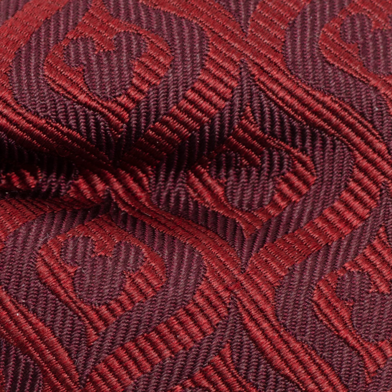 Close-up of a red and brown textured fabric with a geometric pattern Hidden Mickey mouse