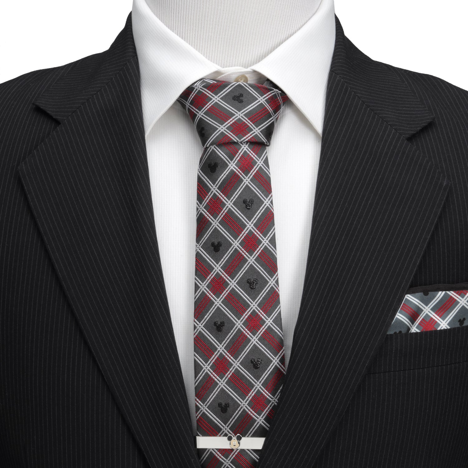 Black suit with a red and gray patterned tie and matching pocket square on a white background