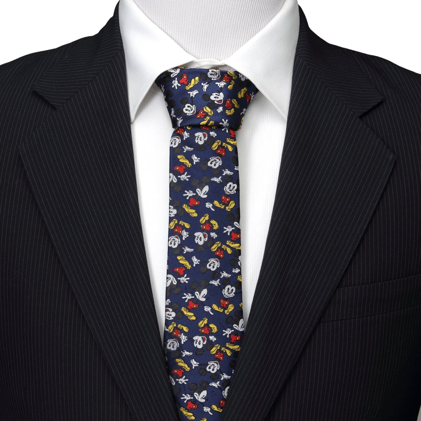 Mannequin wearing a black suit with a colorful patterned tie against a white background