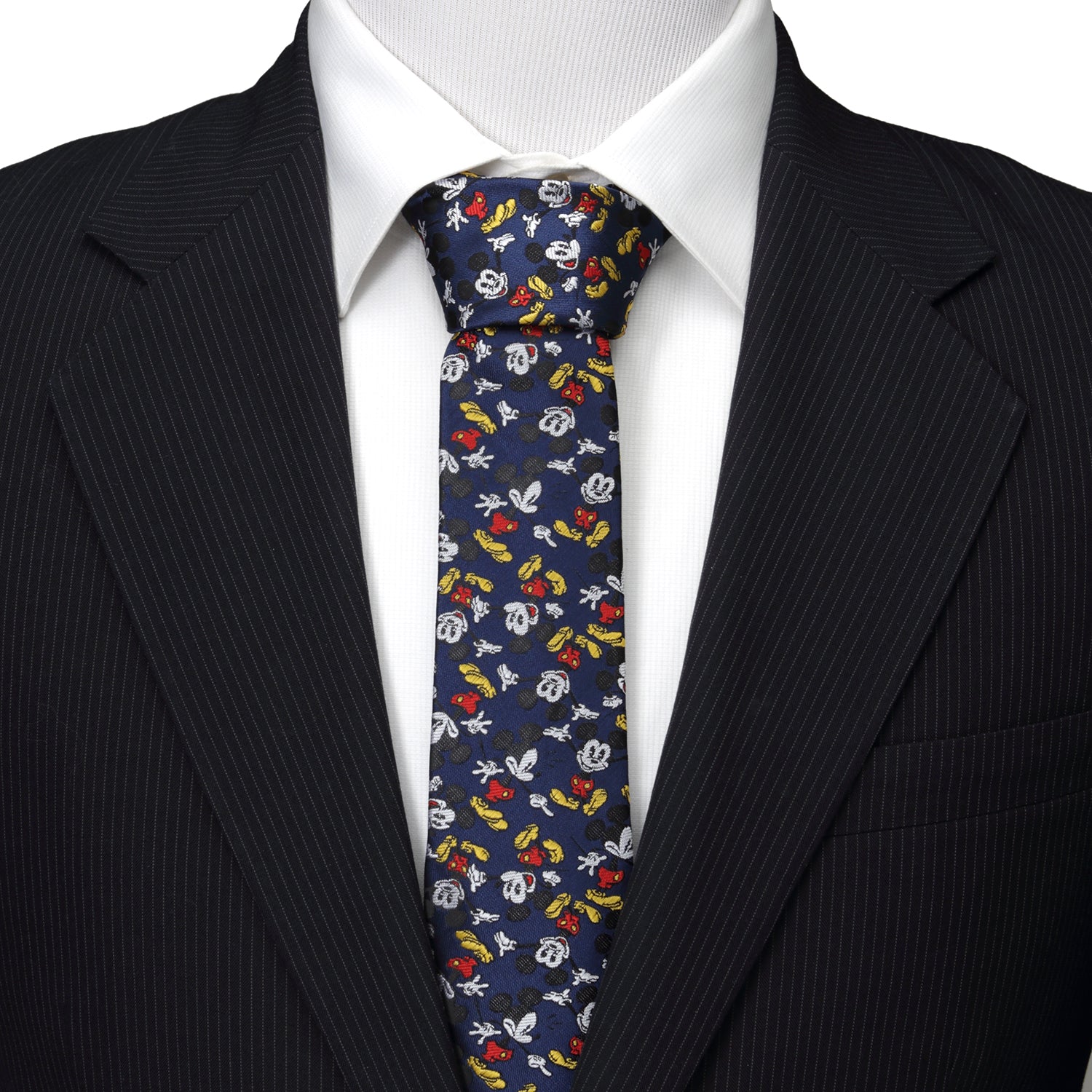 Mannequin wearing a black suit with a colorful patterned tie against a white background