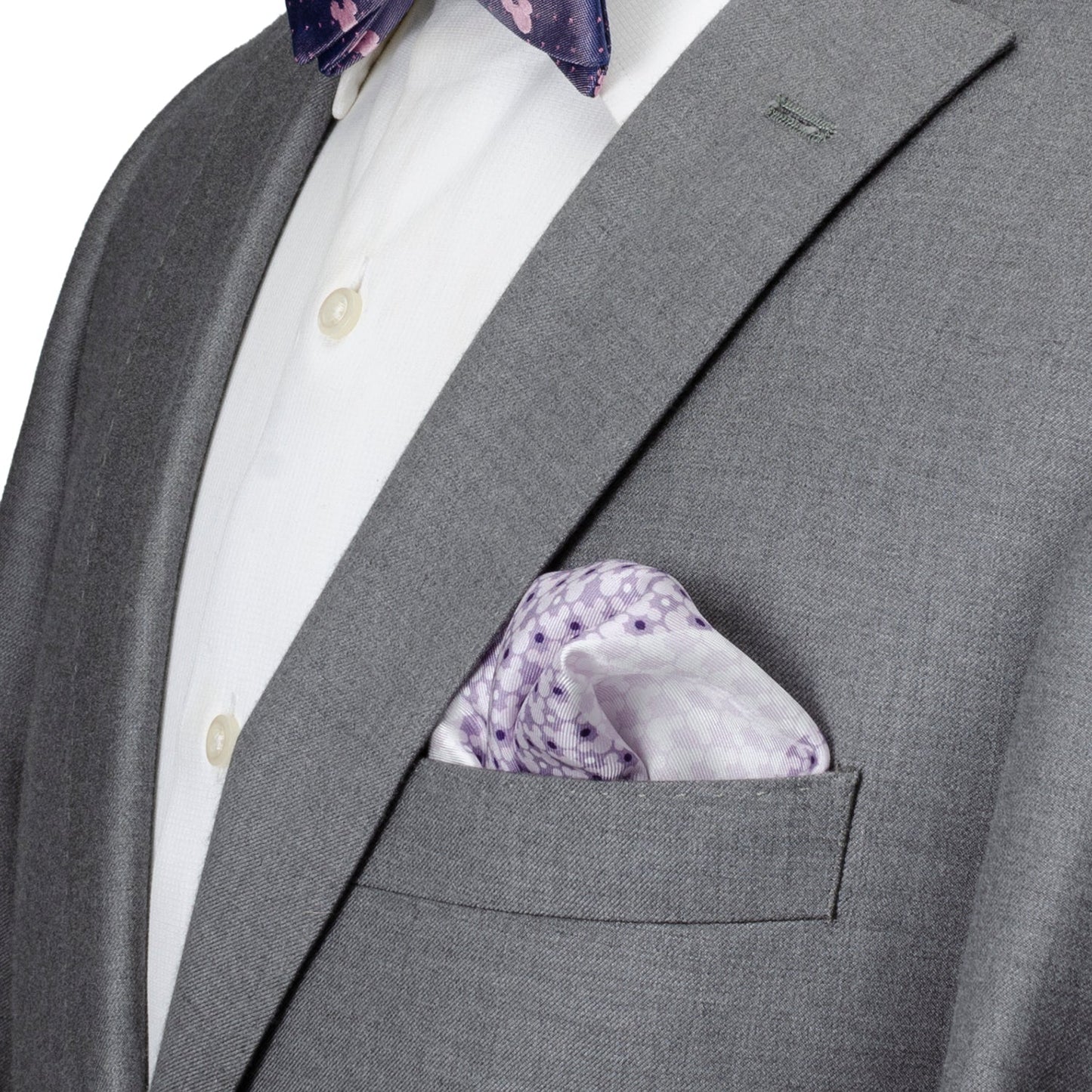 Gray suit jacket with a white shirt and purple floral pocket square.