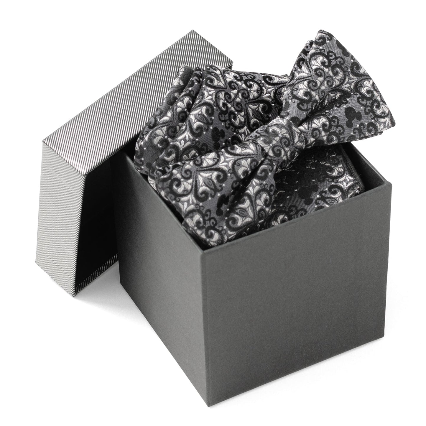 Black and silver patterned bow tie in an open black box on a white background