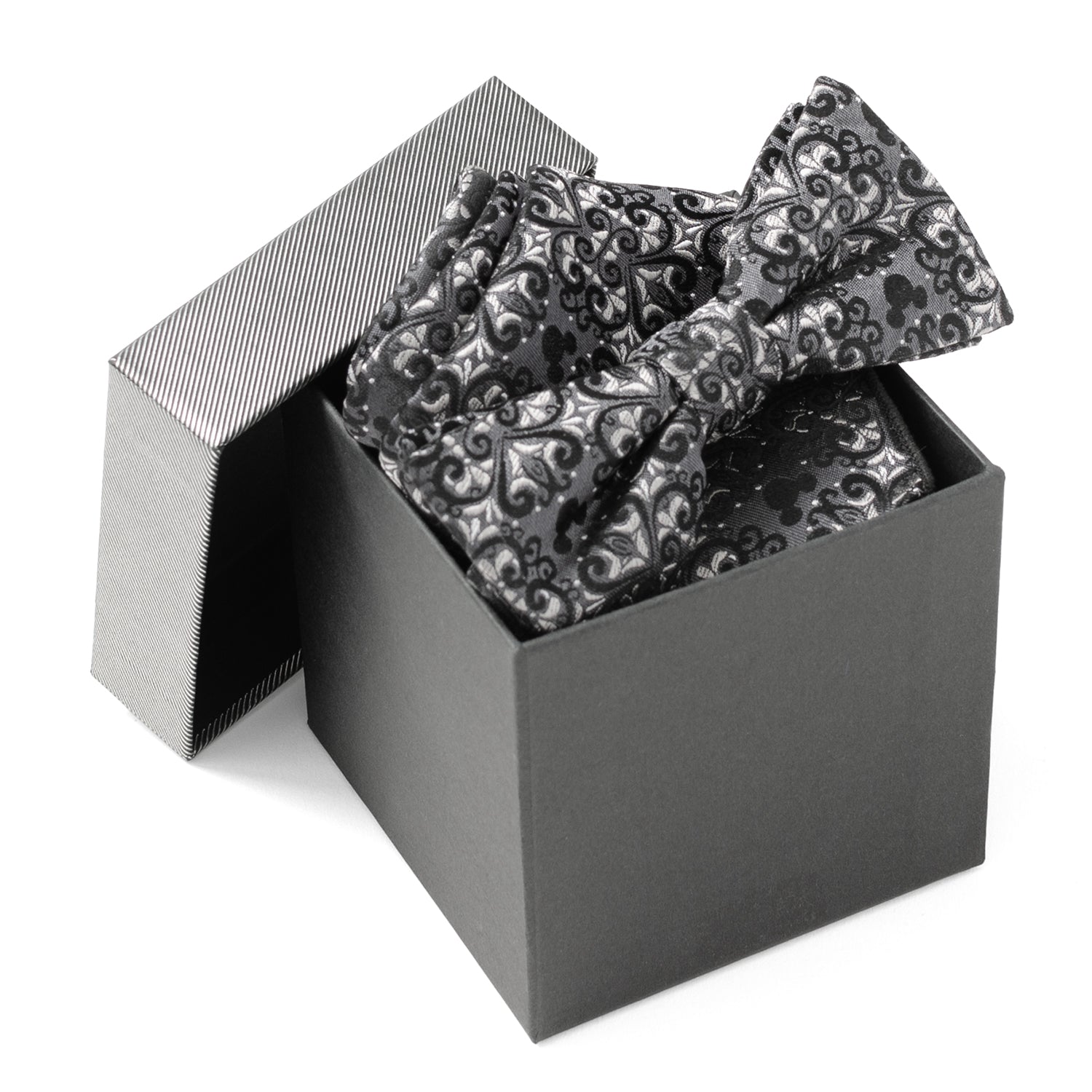 Black and silver patterned bow tie in an open black box on a white background