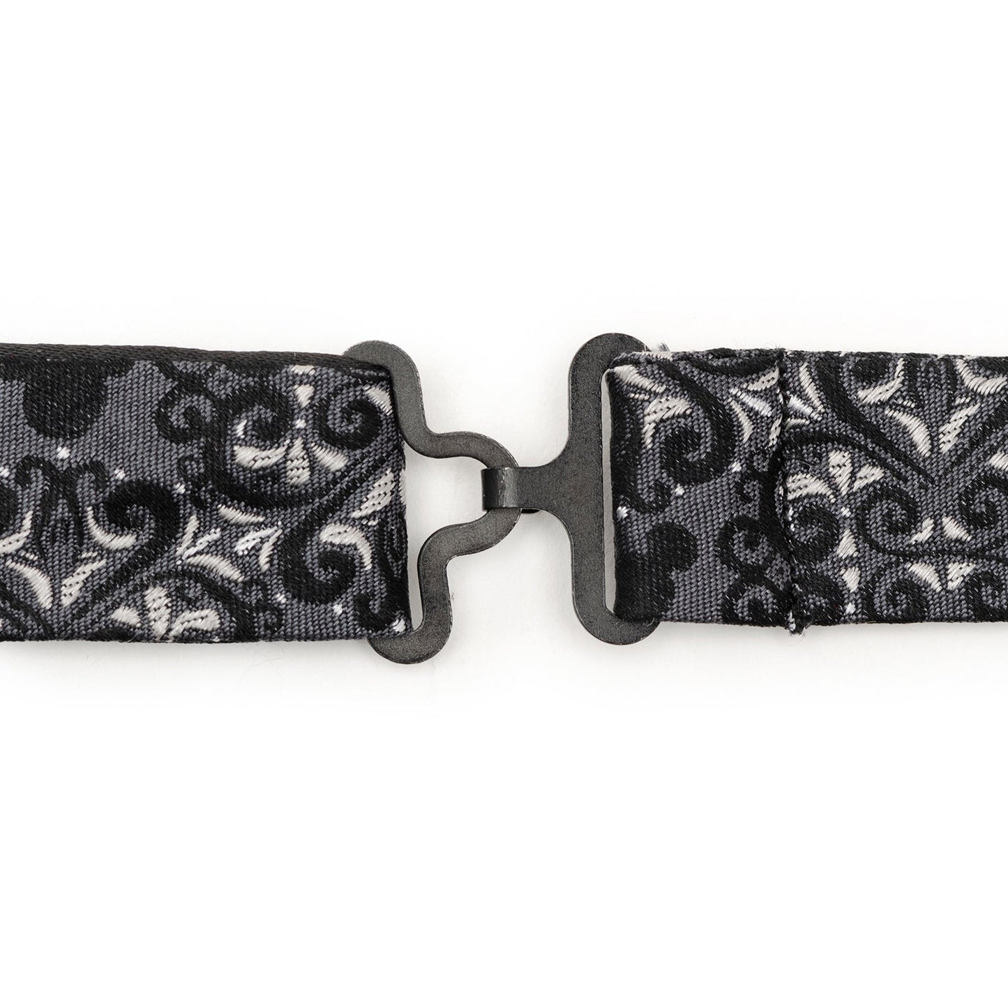 Black and white patterned belt with a metal buckle on a white background
