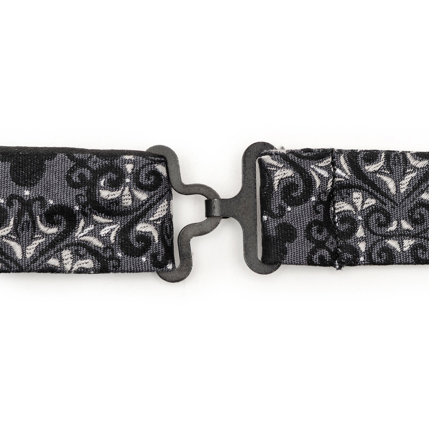 Black and white patterned belt with a metal buckle on a white background