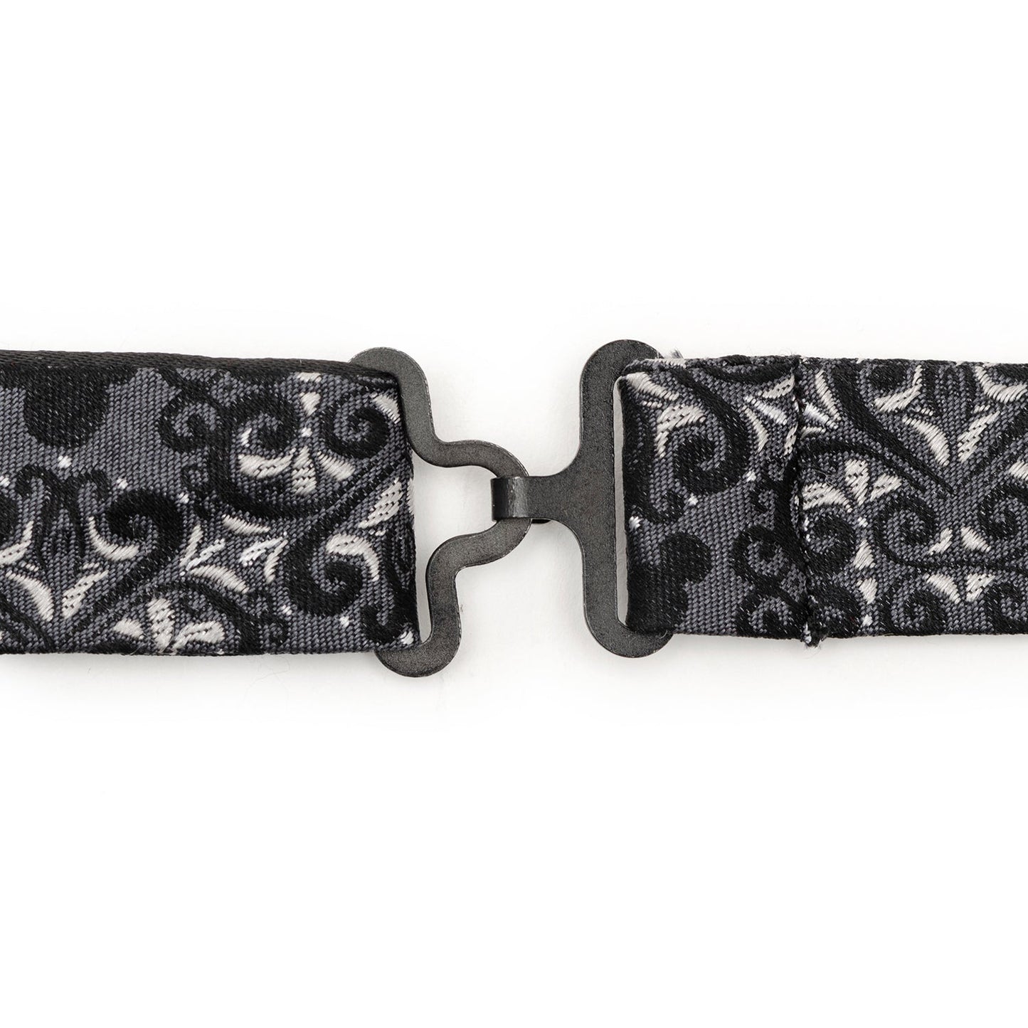 Black and white patterned belt with a metal buckle on a white background