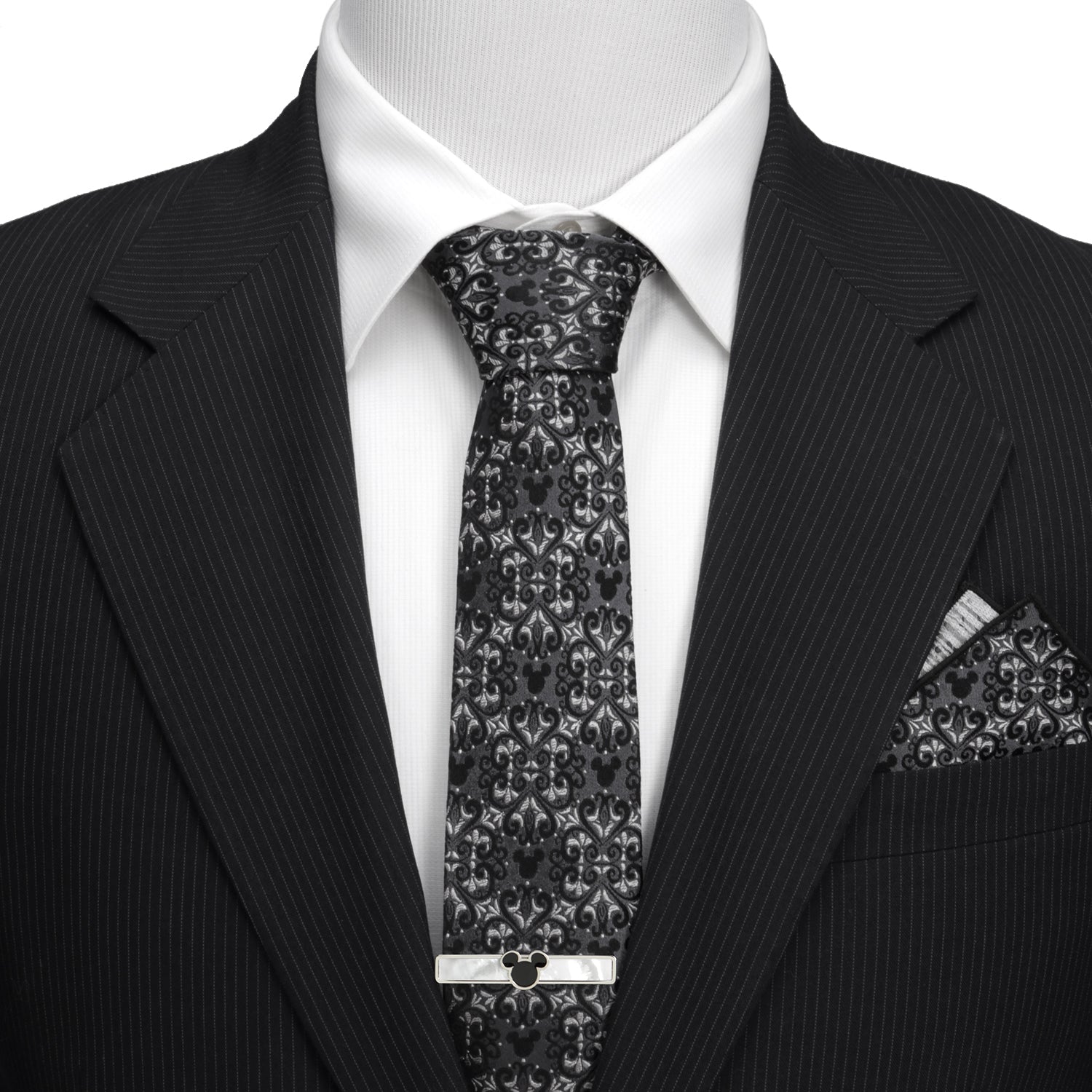 Black pinstripe suit with a patterned tie and pocket square on a mannequin. Hidden Mickey mouse