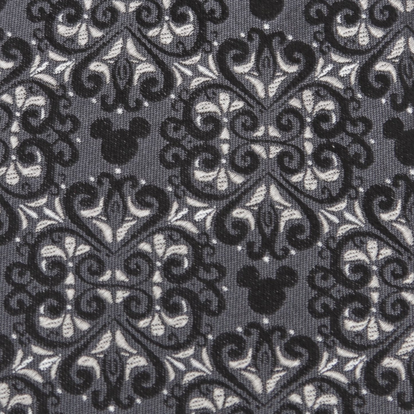 Decorative fabric with black and white pattern and Mickey Mouse head design.