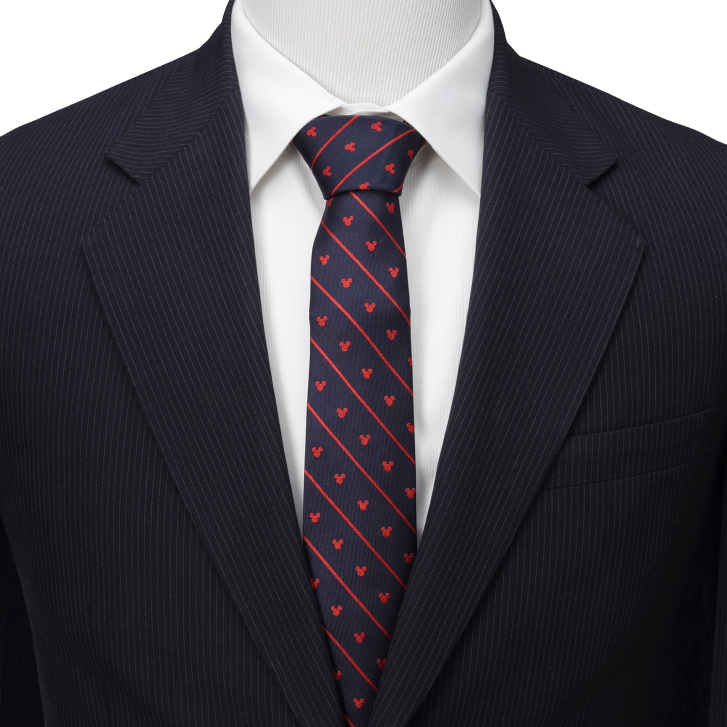 Navy suit with a white shirt and red heart patterned tie on a mannequin.