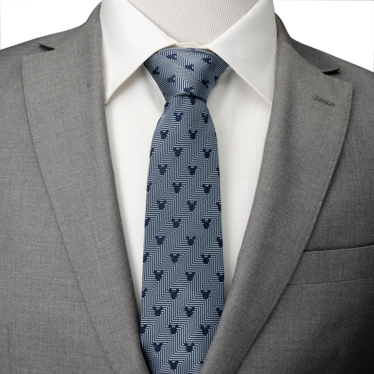 Gray suit with a white shirt and blue patterned tie on a plain background Mickey mouse