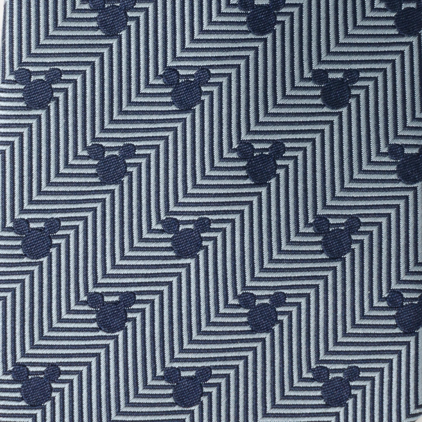Patterned fabric with zigzag design and small mouse head icons on a blue background Mickey mouse