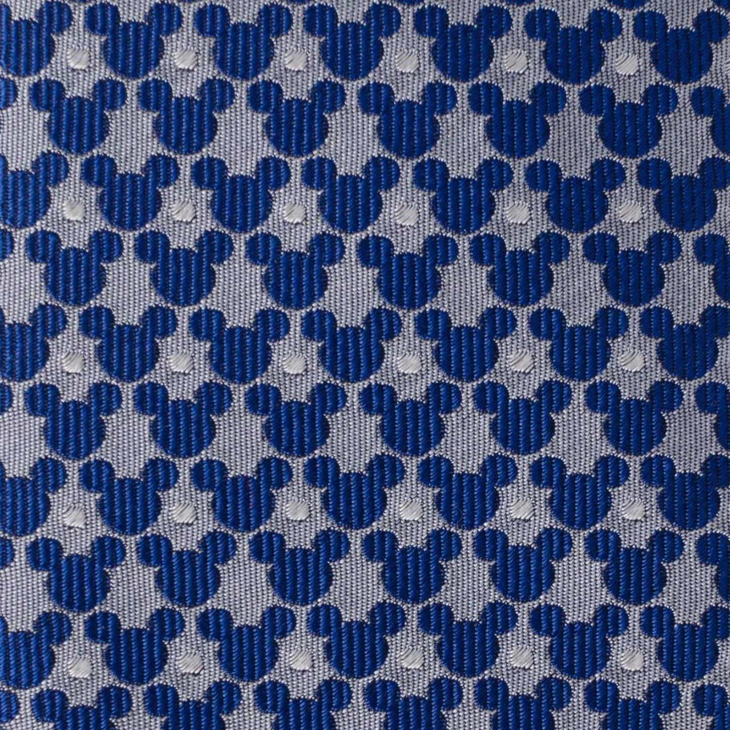 Pattern of blue and gray shapes resembling Mickey Mouse heads on a textured background.