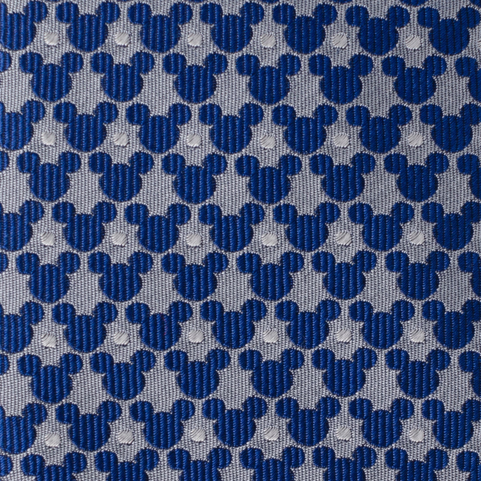 Pattern of blue and gray shapes resembling Mickey Mouse heads on a textured background.