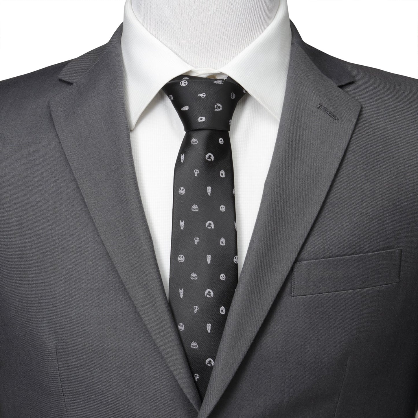 Gray suit with a white shirt and patterned tie on a mannequin.