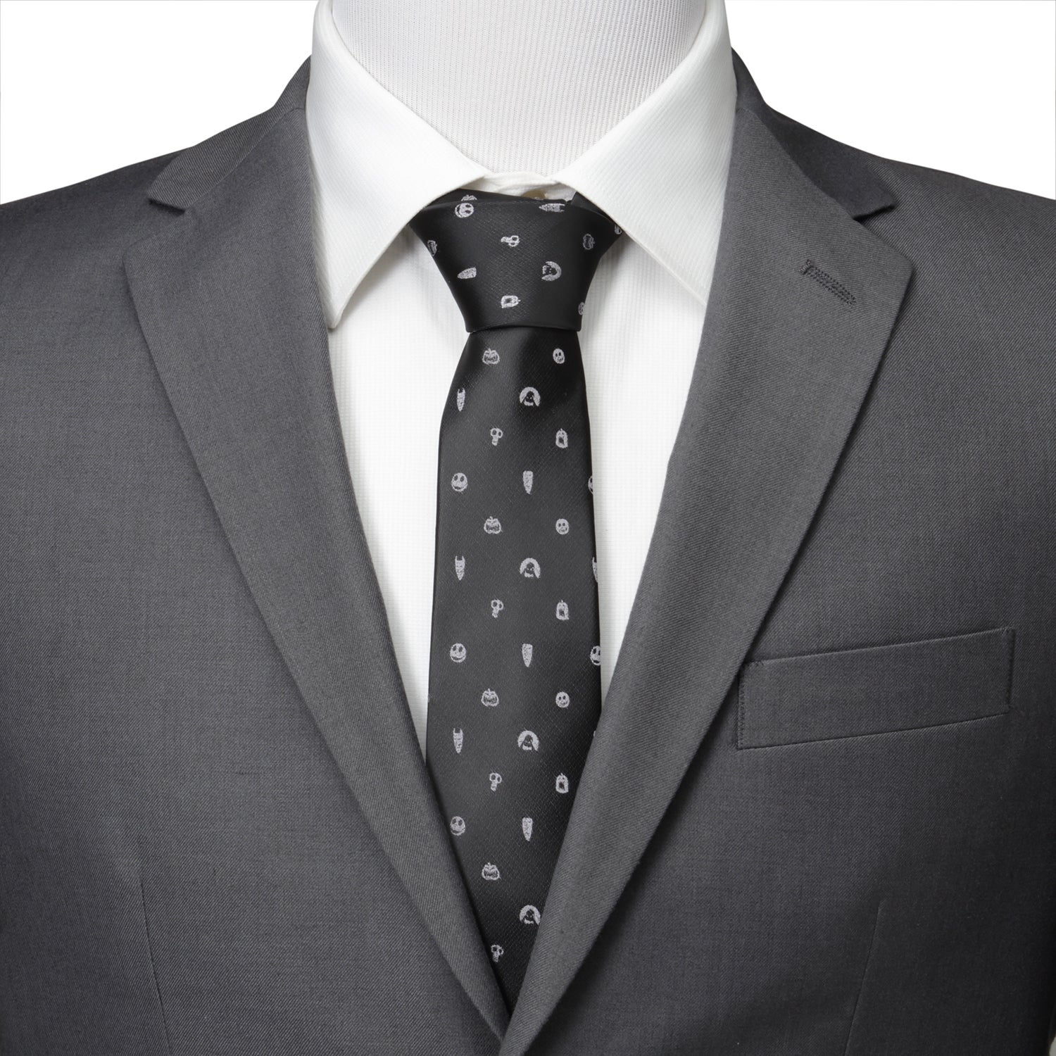 Gray suit with a white shirt and patterned tie on a mannequin.