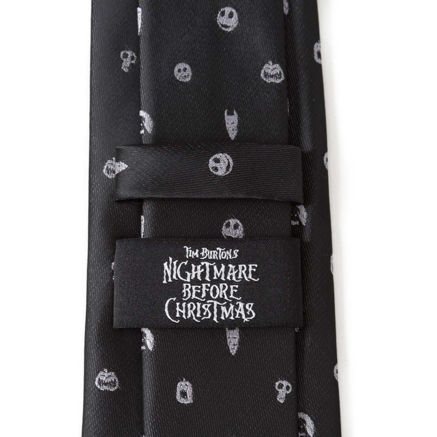 Black tie with white skull patterns and 'Nightmare Before Christmas' label on a white background